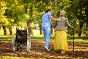 Seniors socializing in a bright common area with comfortable seating and large windows.