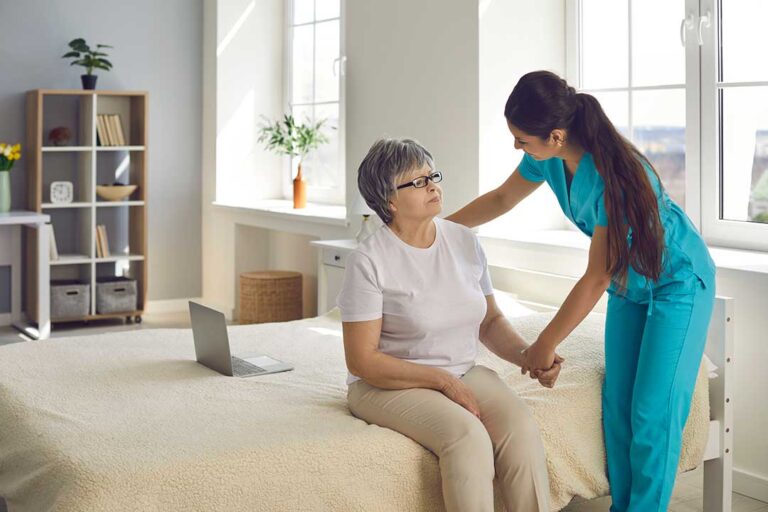 Older assisted living resident reviewing care documents with a family member at a table